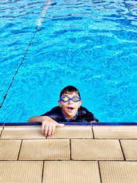 High angle portrait of boy swimming in pool