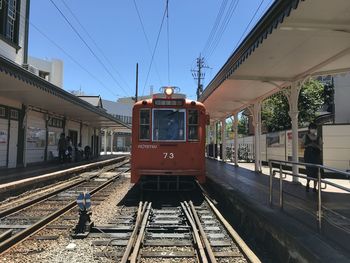 Train at railroad station against sky