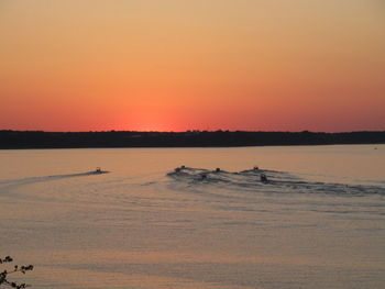 Scenic view of sea against clear sky during sunset