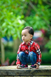 Cute boy sitting outdoors