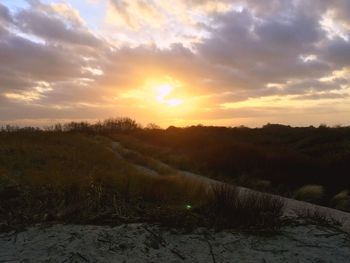 Scenic view of field against sky during sunset