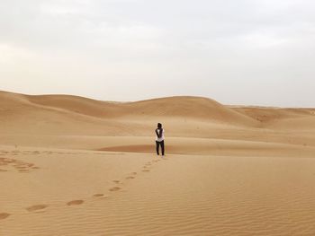 Rear view of man in desert