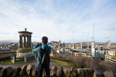 Rear view of man standing on the city