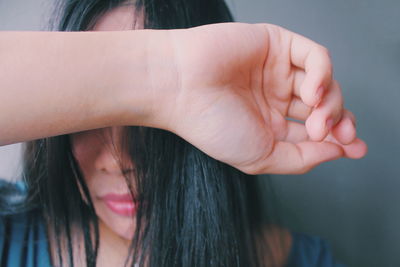 Close-up of woman with hand on hair