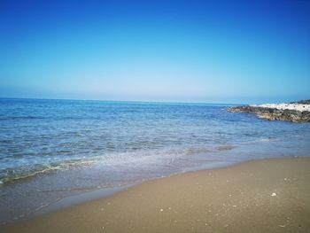 Scenic view of sea against clear blue sky
