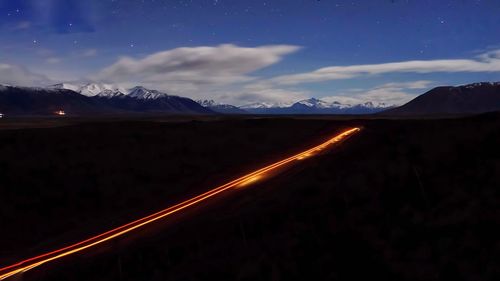 Scenic view of mountains against sky at night