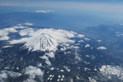 Aerial view of snowcapped mountains against sky