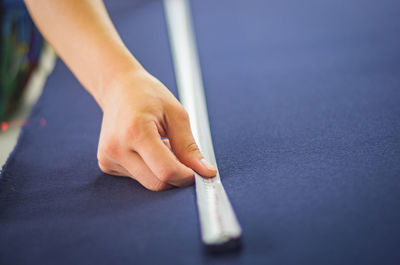 Close-up of hand holding hands on table