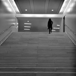 Rear view of woman walking on staircase