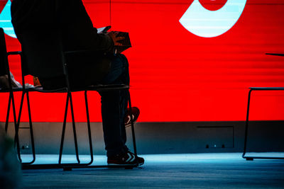 Low section of man sitting on chair