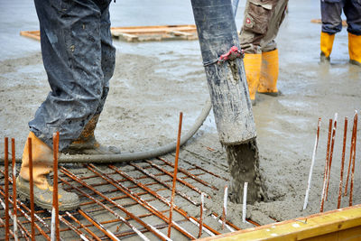 Low section of worker working at construction site