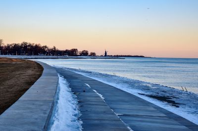 Scenic view of frozen lake against clear sky during winter