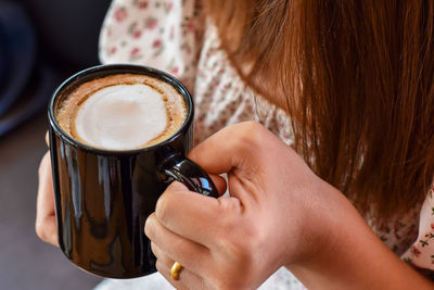 Woman holding coffee cup
