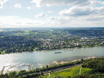 Aerial view of river and cityscape against sky