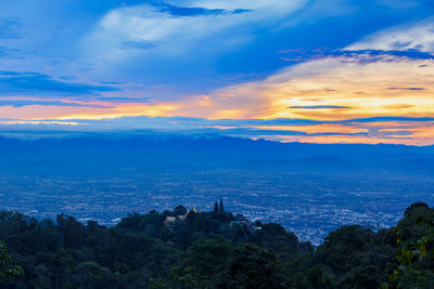 Scenic view of city and buildings against sky during sunset