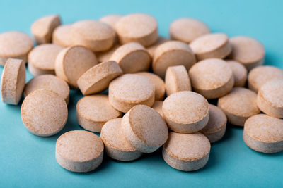 Orange pills vitamin c. pills on blue background.