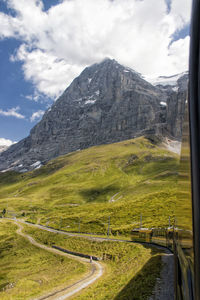 Scenic view of mountains against cloudy sky