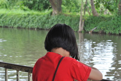 Girl against lake in forest