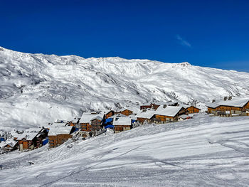 Scenic view of snowcapped mountains against clear blue sky