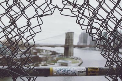 Cityscape seen through chainlink fence