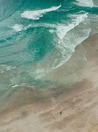 High angle view of waves on beach