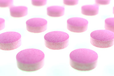 Close-up of multi colored candies against white background