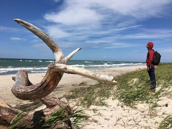 Man standing on beach against sky
