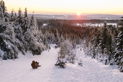 Scenic view of snow covered field against sky during winter