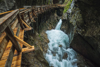 Water flowing through rocks on bridge