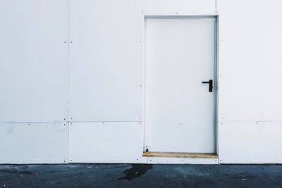 Closed white door of building