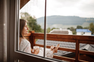 Woman relaxing in balcony