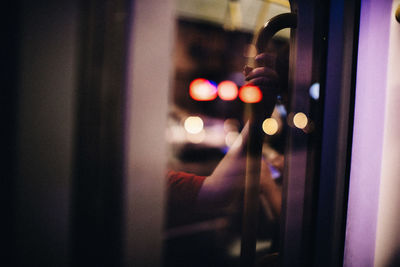 Close-up of hand holding illuminated light at night