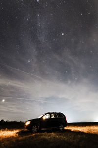 Built structure on field against sky at night