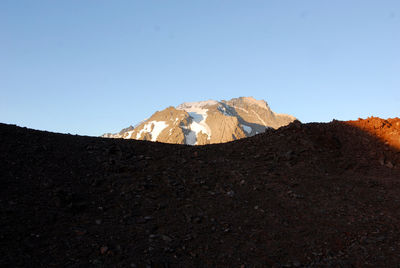 Scenic view of rocky mountains against clear blue sky