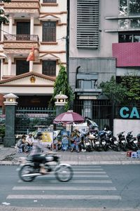 Blurred motion of motorcycle against building on street