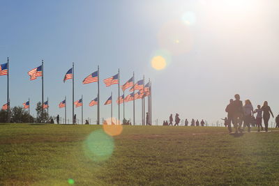 Group of people on field against sky