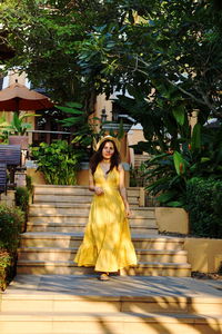Young woman wearing mask against trees