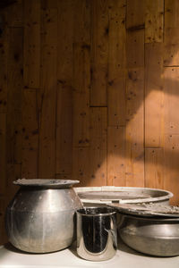 Silver pots in the ceramic studio on a wooden background