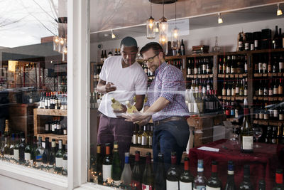 Multi-ethnic colleagues discussing in wine shop