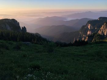 Scenic view of landscape against sky at sunset