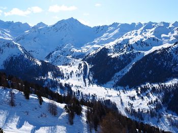 Scenic view of snow covered mountains against sky