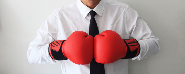 Midsection of man standing against white background