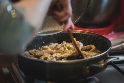 Close-up of person preparing food in kitchen