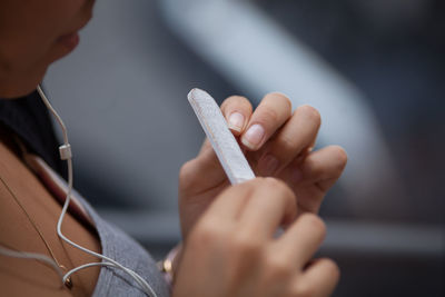 Midsection of man holding mobile phone