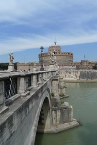 Ponte sant angelo over tiber river by hadrian tomb against sky