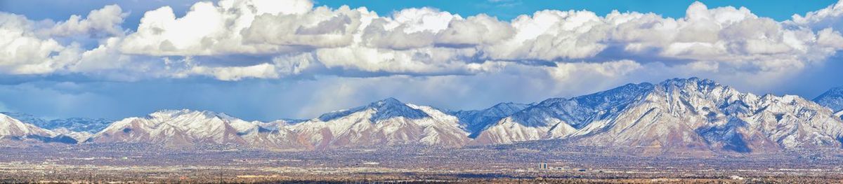 Panoramic view of snowcapped mountains against sky