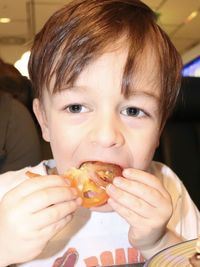 Close-up portrait of boy eating food