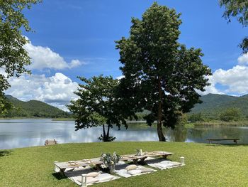 Scenic view of lake by trees against sky