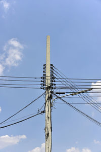 Low angle view of electricity pylon against sky