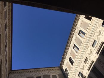 Low angle view of historic building against clear blue sky